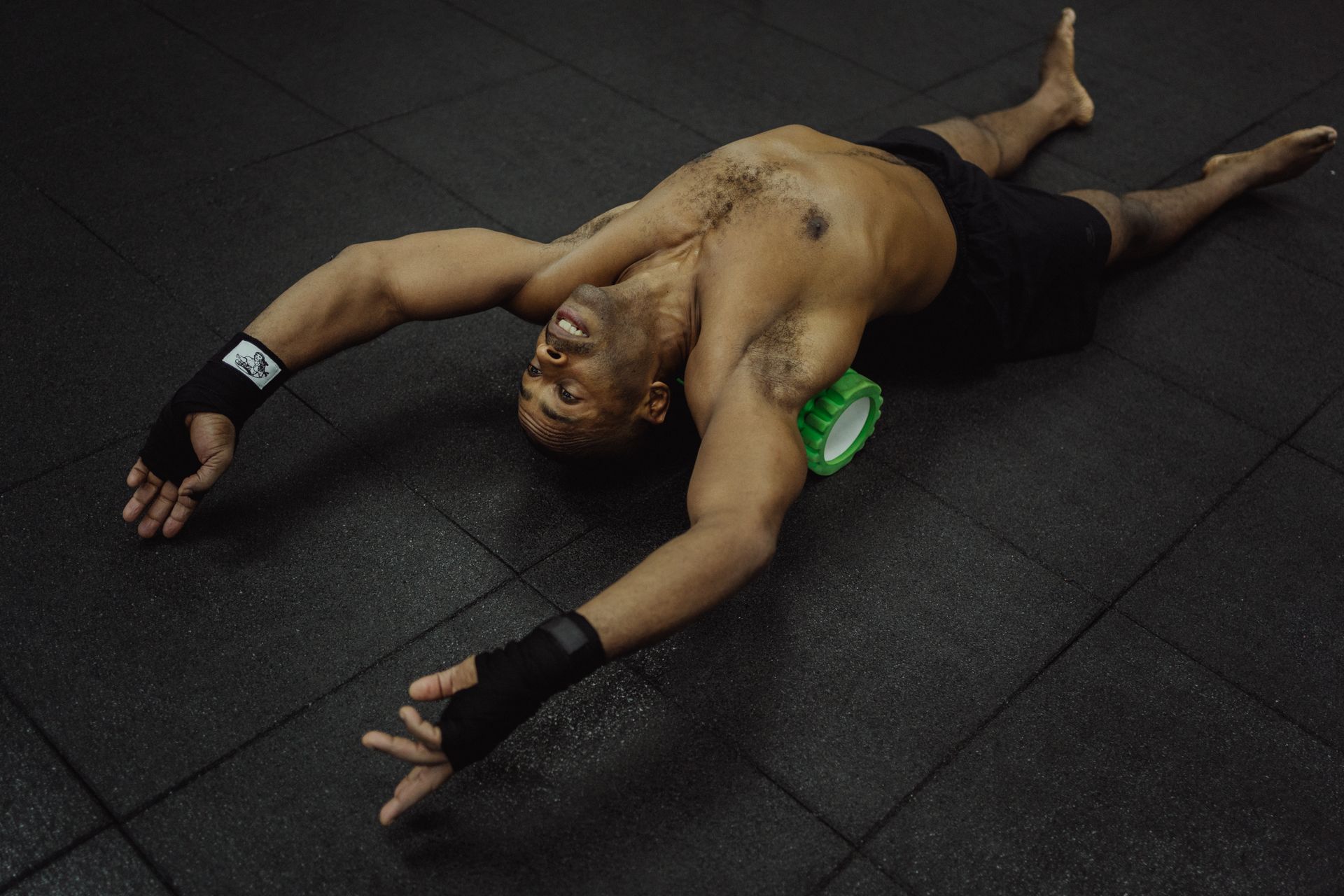 Athlete foam rolling for muscle recovery on a gym floor — BPC-157 and TB-500 recovery peptides